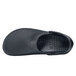 A close-up of a black Shoes For Crews unisex casual shoe with rubber soles.