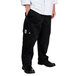 A person wearing Chef Revival black cargo pants and a white shirt.