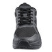 A close up of a black Shoes For Crews Energy II athletic shoe with laces.