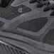 A black Shoes For Crews Energy II athletic shoe with a mesh upper and rubber sole.