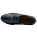 A close-up of a black Shoes For Crews Madison III women's dress shoe with laces.