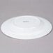 An Arcoroc white porcelain dinner plate with a small rim.