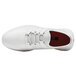 A white Shoes For Crews Karina athletic shoe with red accents and laces.