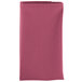 A folded pink Intedge cloth napkin.