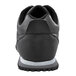 The back view of a black Shoes For Crews Avery athletic shoe with a white sole.