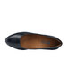 A black leather flat dress shoe with a brown sole.