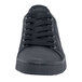 A close up of a black MOZO casual shoe with laces.