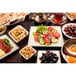 A white rectangular melamine platter on a table with various types of food and drinks.