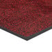 A red carpet mat with black and red spots.