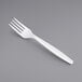 A Visions white plastic fork on a gray background.
