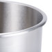 A close up of a Robot Coupe stainless steel bowl with a lid.