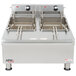 An APW Wyott electric countertop deep fryer with two baskets.