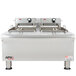 An APW Wyott stainless steel commercial countertop deep fryer with two large pots.