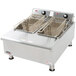 An APW Wyott commercial countertop electric deep fryer with two baskets.