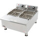 An APW Wyott heavy duty electric countertop deep fryer with two pans on top.