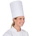 A woman wearing a Royal Paper disposable chef hat.