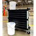 A black cart with a white and black bucket on it, one labeled "clean water" and one labeled "waste water" with a black cart.