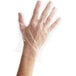 A hand wearing a Choice clear plastic glove.