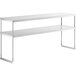 An Avantco stainless steel double deck overshelf with metal legs on a white table.