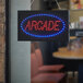 A rectangular LED arcade sign with blue lights in the middle.