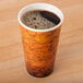 A Dart Fusion Escape foam coffee cup on a counter full of black coffee.
