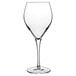 A clear Luigi Bormioli Atelier white wine glass with a long stem.