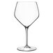 A clear Luigi Bormioli Atelier Chardonnay wine glass with a thin stem.