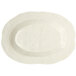 A white oval platter with a wavy ivory rim.
