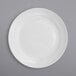 A close-up of an International Tableware Bristol porcelain bowl with a white surface and rolled edge.