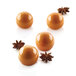 A close-up of three round orange truffles.