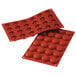 Two red Silikomart silicone baking molds with 24 pomponnette cavities.