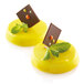 Two yellow desserts in Silikomart silicone molds with chocolate and mint on top.