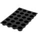 A black Silikomart silicone baking mold with cylindrical cavities.