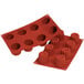 A red Silikomart silicone baking mold with 8 big Bordelais cavities.
