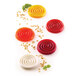 A white silicone baking mold with red, yellow, and white swirled objects.