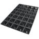 A black silicone baking mold tray with many square pyramid shapes.