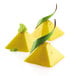 A group of yellow pyramid-shaped desserts with green leaves on top.
