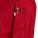 A close up of the tool pocket on a red Uncommon Chef long sleeve chef coat.