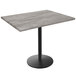 A Holland Bar Stool EnduroTop table with a black base and greystone wood laminate top.