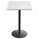 A white square Holland Bar Stool outdoor bar height table with a white top and round base.