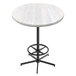 A white round Holland Bar Stool EnduroTop bar height table with a white ash wood laminate top and a black foot rest base.
