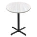A white Holland Bar Stool EnduroTop round table with a white surface and a black cross base.