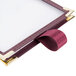 A burgundy sewn edge Menu Solutions table tent with white interior panels.