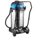 A Lavex stainless steel wet/dry vacuum cleaner on wheels with a black and blue toolkit.