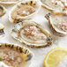 A close-up of a plate of Rappahannock River Oysters with a lemon slice on a pile of salt.