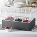 A Vollrath display kit with wild food pans filled with different kinds of berries.