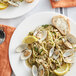 A plate of pasta with Rappahannock Olde Salt Littleneck Clams and lemon slices.