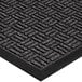 A close-up of a black rubber Lavex parquet entrance mat with a pattern.