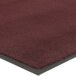 A burgundy carpet mat with black border.