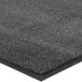 A close up of a Lavex charcoal gray carpet mat with black edges.